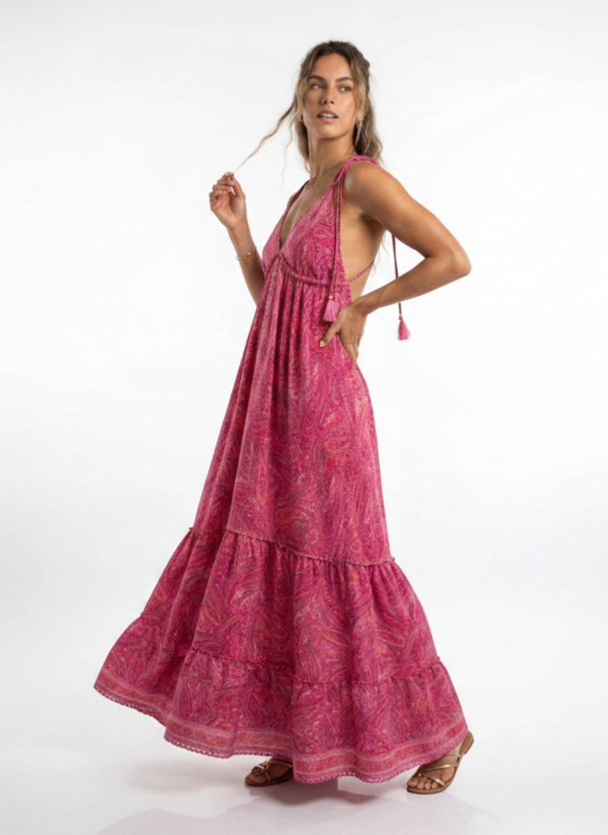 Woman wearing a pink dress with a white background