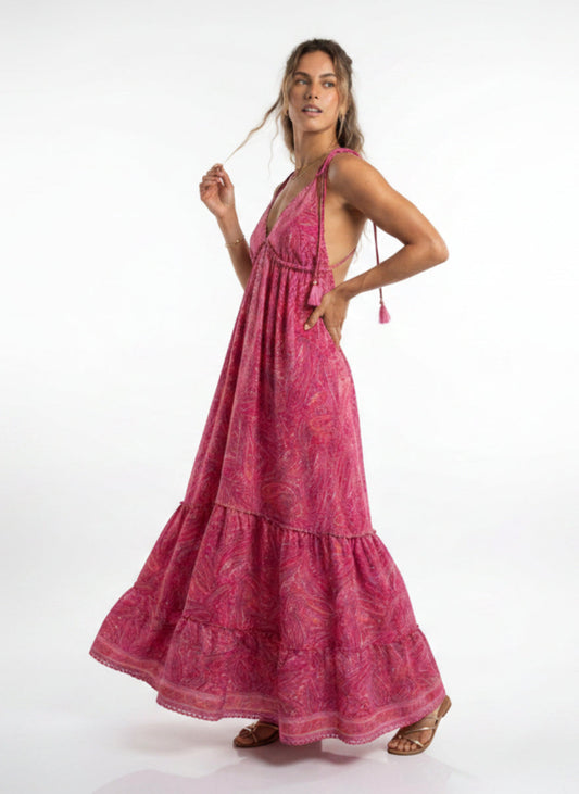 Woman wearing a pink dress with a white background